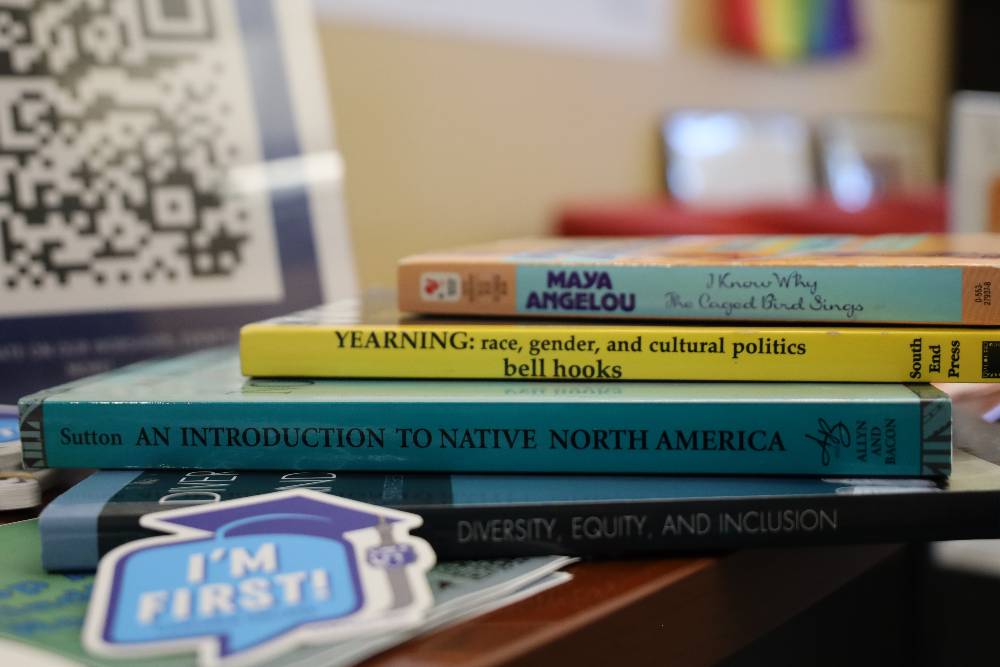 Stack inclusion, advocacy, and community focused books including Maya Angelou and bell hooks