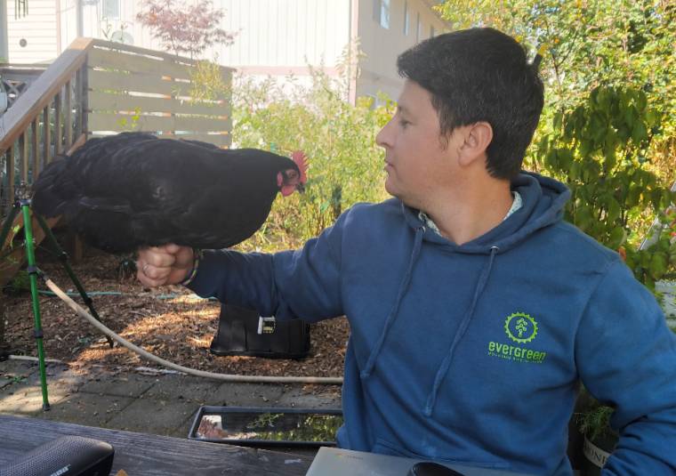 Luis talking to chicken.