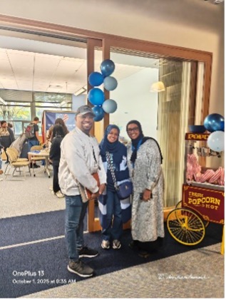 Sean Poellnitz, Alia Mahdi, and Ifrah Mohamed in front of the Inclusion & Advocacy Center