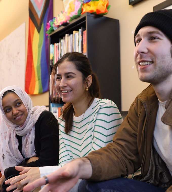 Diversity Center A student looking at their homework with another student, engaged in collaborative study or discussion.