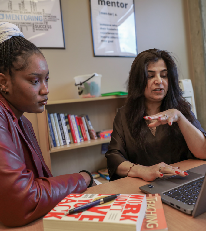 Diversity Center Student comparing notes with another students.