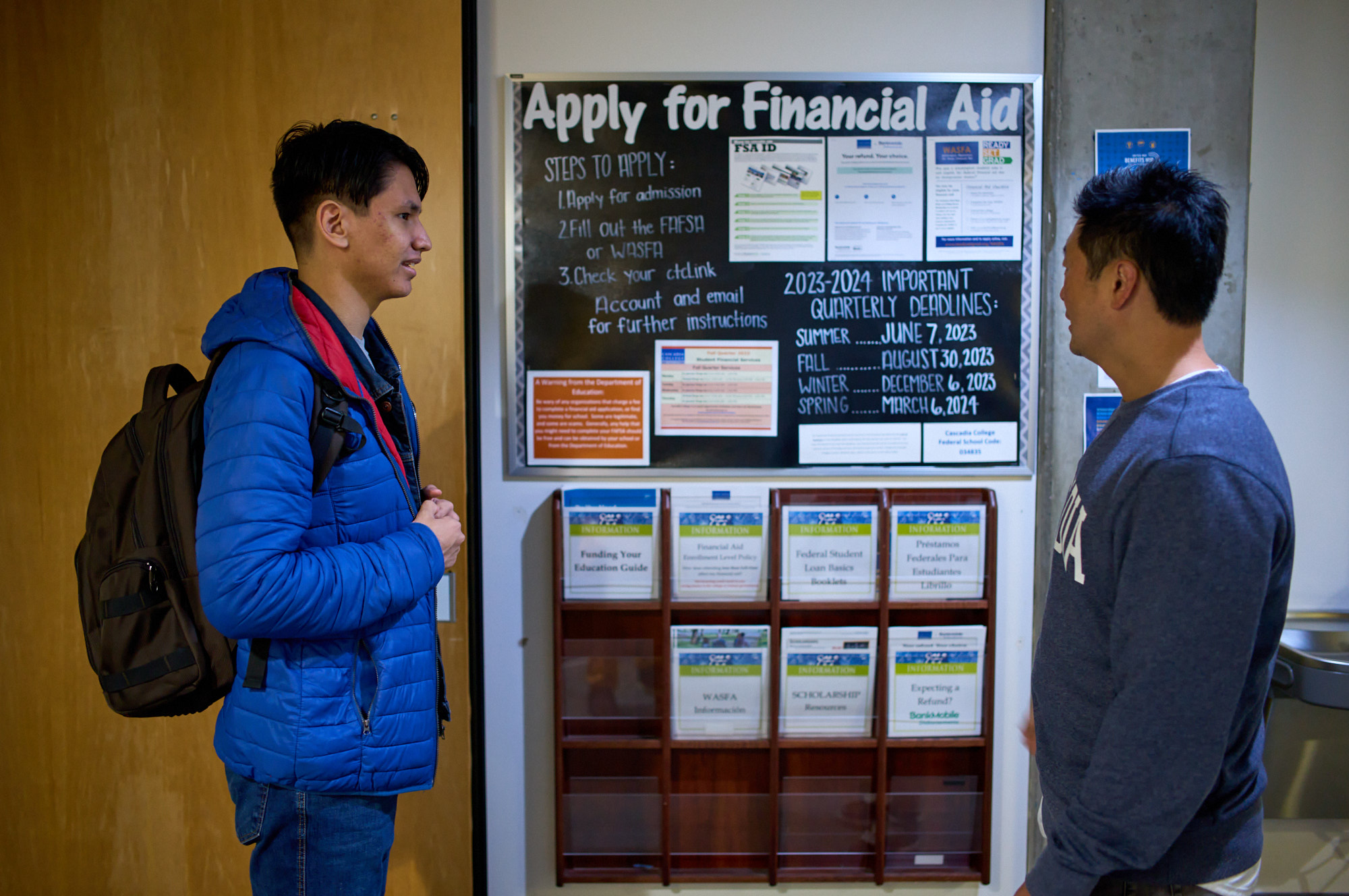 Campus Life A student engaged in conversation with an advisor, discussing financial aid and seeking guidance.