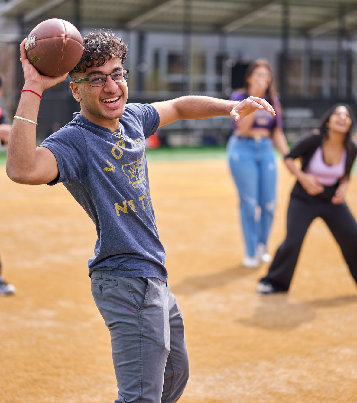 Activities and Recreation Center Image of a student playing football with other students